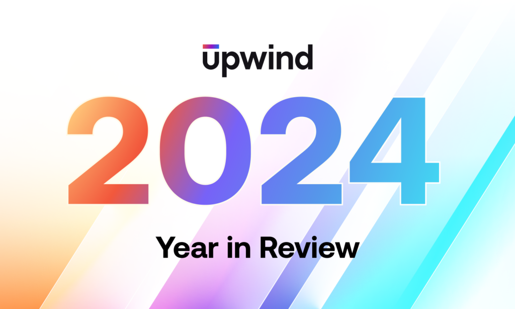 A gradient-colored graphic with the word Upwind at the top, featuring large numbers 2024 in the center. Below, it says Year in Review on a backdrop of diagonal lines in pastel colors.