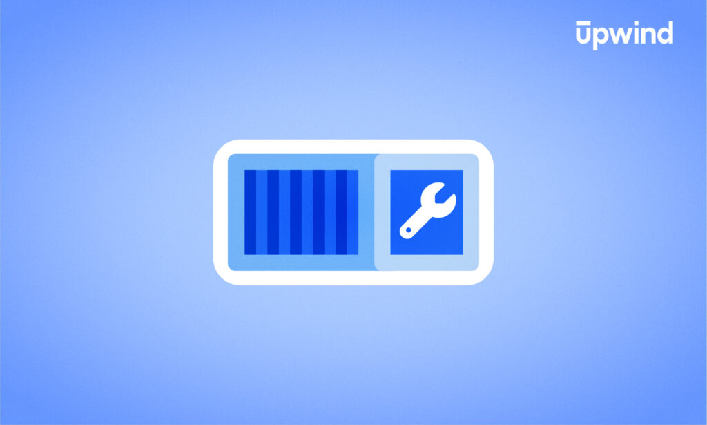 Illustration of a container icon on a blue background, featuring a blue toolbox with a wrench beside it. The container is adorned with vertical blue stripes, and Upwind is written in white in the top right corner, subtly hinting at Kubernetes security tools.